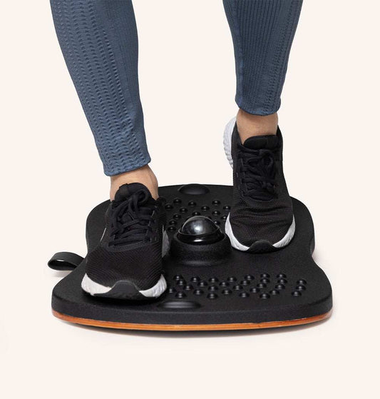 Person using Standy Balance Board for balance training and active standing work, enhancing posture and core strength.