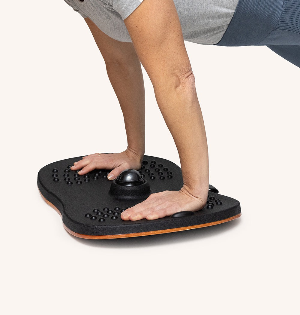 Person using Standy Balance Board for stability training and ergonomic standing work.